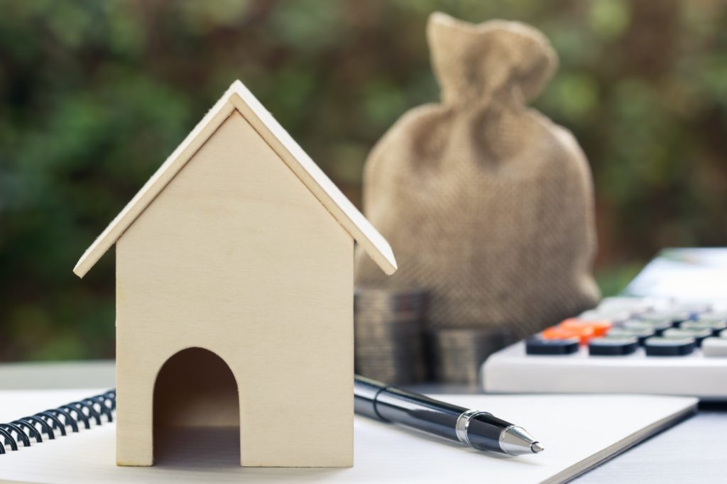 wooden house with calculator to the side