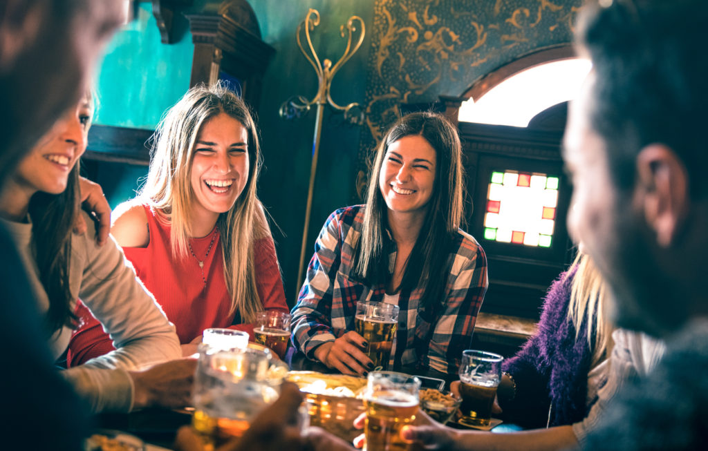 Group of happy friends drinking beer at brewery bar restaurant