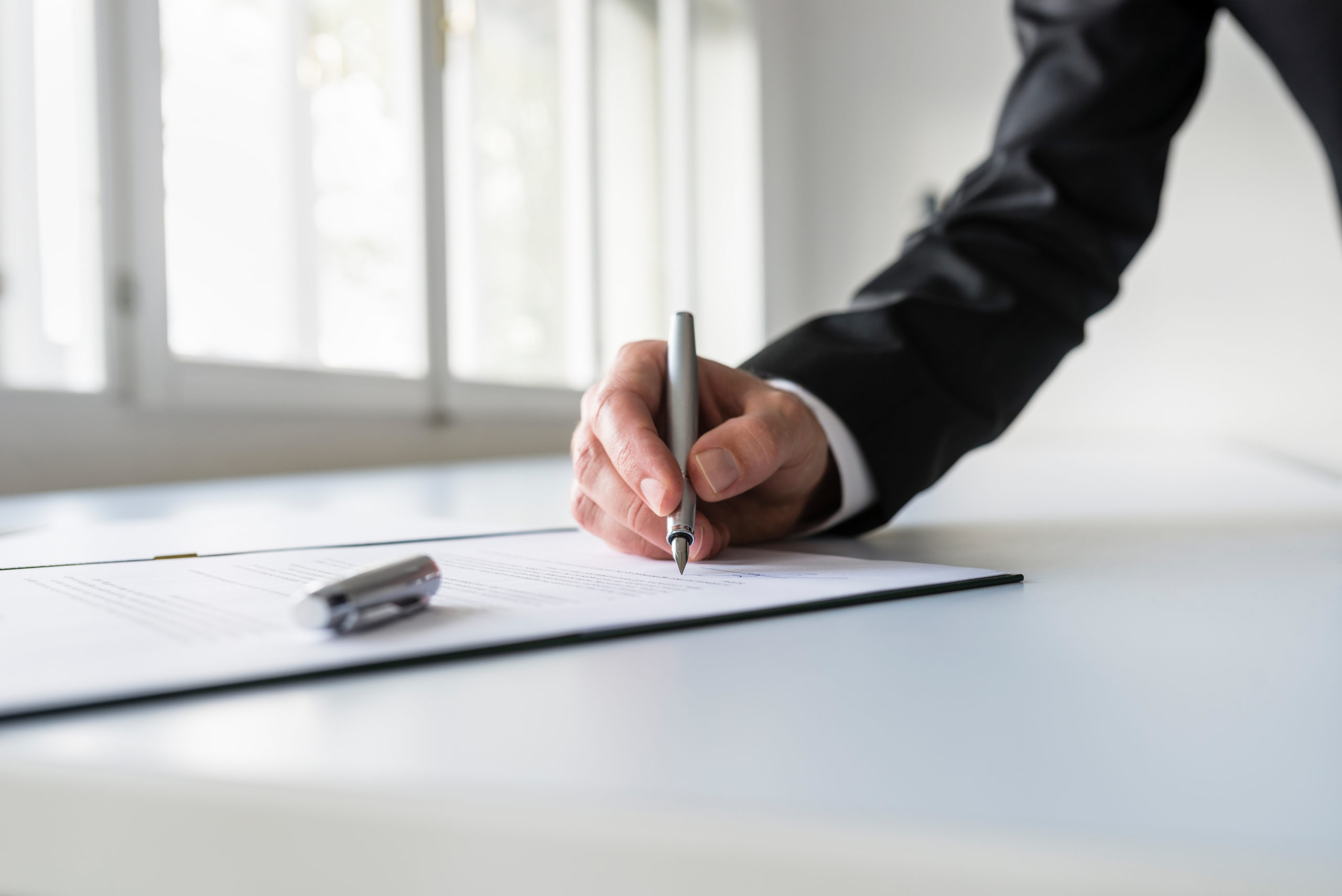 Man in business suit signing contract