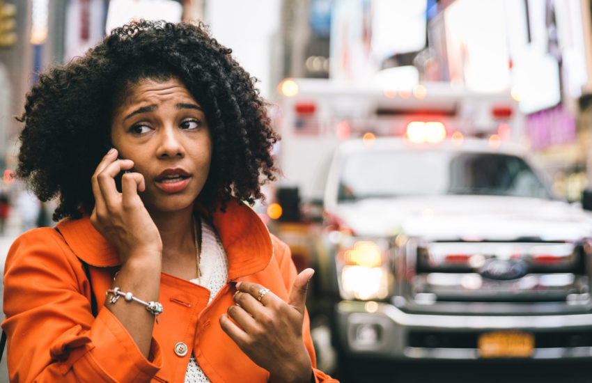 woman calling 911 in New york city. concept about car accidents and emergency